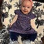 baby, chair, child, clothing, cute, dress, fashion, floral_pattern, footwear, girl, happy, headband, indoor, infant, navy_leggings, palm_tree_pattern, portrait, seated, smiling, white_shoes