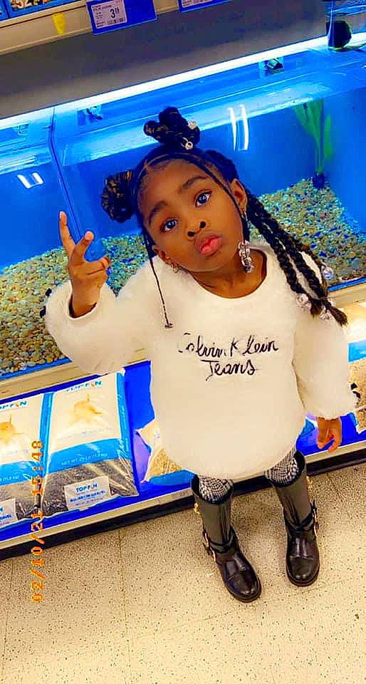 Kendra is registered to the contest to win money with this photo: blue, boot, child, electric_blue, fun, happy, leisure, logo, mascot, person, play, product, recreation, retail, room, sandal, shopping, sock, surprise, t_shirt