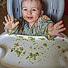 baby, high_chair, messy, food, green_food, smiling, child, happy, hands, face, indoor, meal, clothing, cute, fun, playful, feeding, kitchen, toddler, expression
