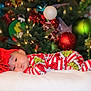 accessories, baby, bodypart, clothing, couch, face, finger, furniture, hand, hat, head, lighting, newborn, ornament, person, photography, plant, portrait, sphere, tree