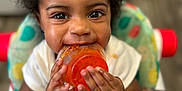 Promise joined the competition — help win amazing prizes! toddler, child, baby_food, high_chair, curly_hair, smiling, messy, orange_food, cute, hands, face, indoor, person, infant, feeding, happy, closeup, seat, playful, young