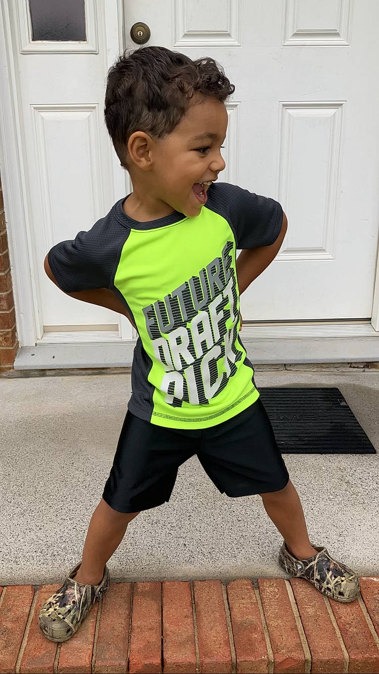 Julian is registered to the contest to win money with this photo: active_pants, baby_toddler_clothing, door, face, happy, head, human_body, jersey, knee, neck, person, shoe, shoulder, sleeve, sleeveless_shirt, sportswear, sweatpant, t_shirt, thigh, toddler