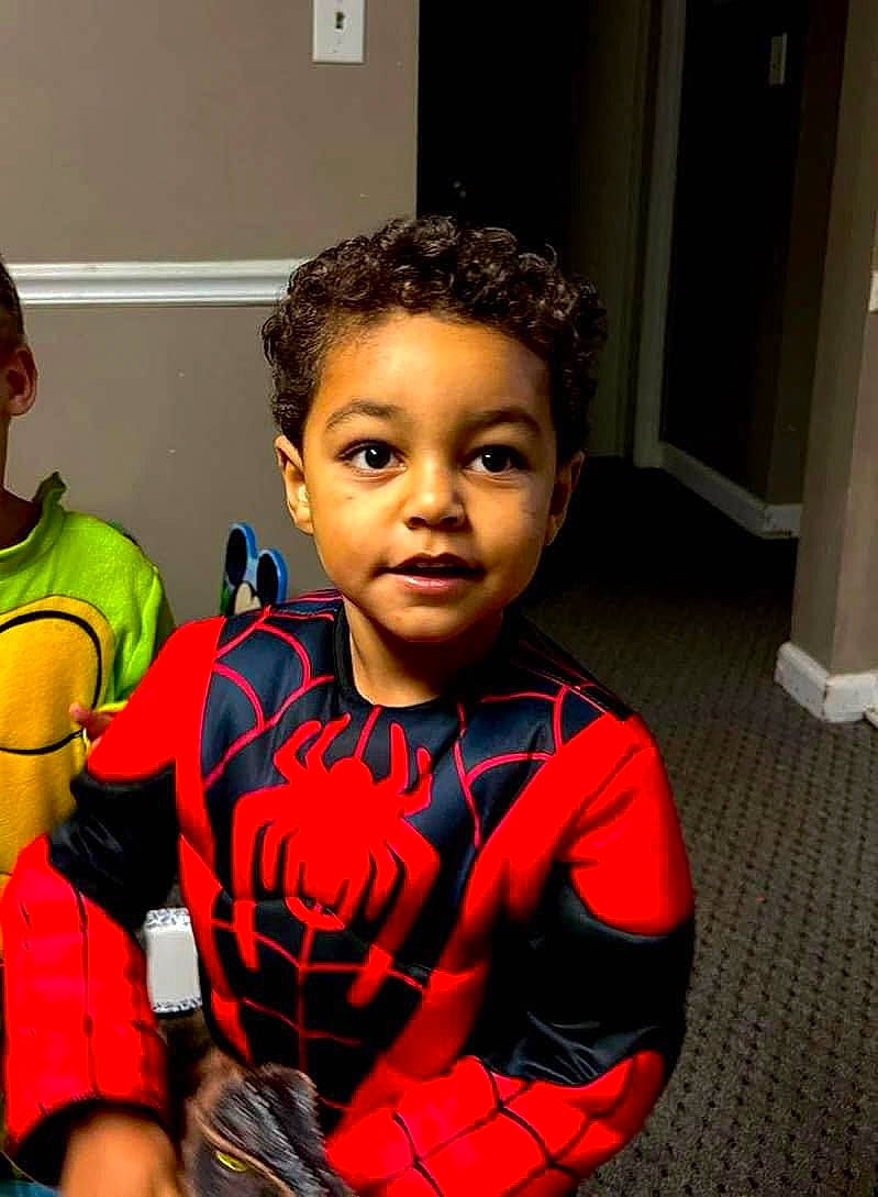 Julian is registered to the contest to win money with this photo: baby, carmine, child, costume, event, fashion_accessory, fashion_design, fictional_character, flooring, fun, happy, pattern, person, personal_protective_equipment, play, room, t_shirt, toddler, toy, tradition