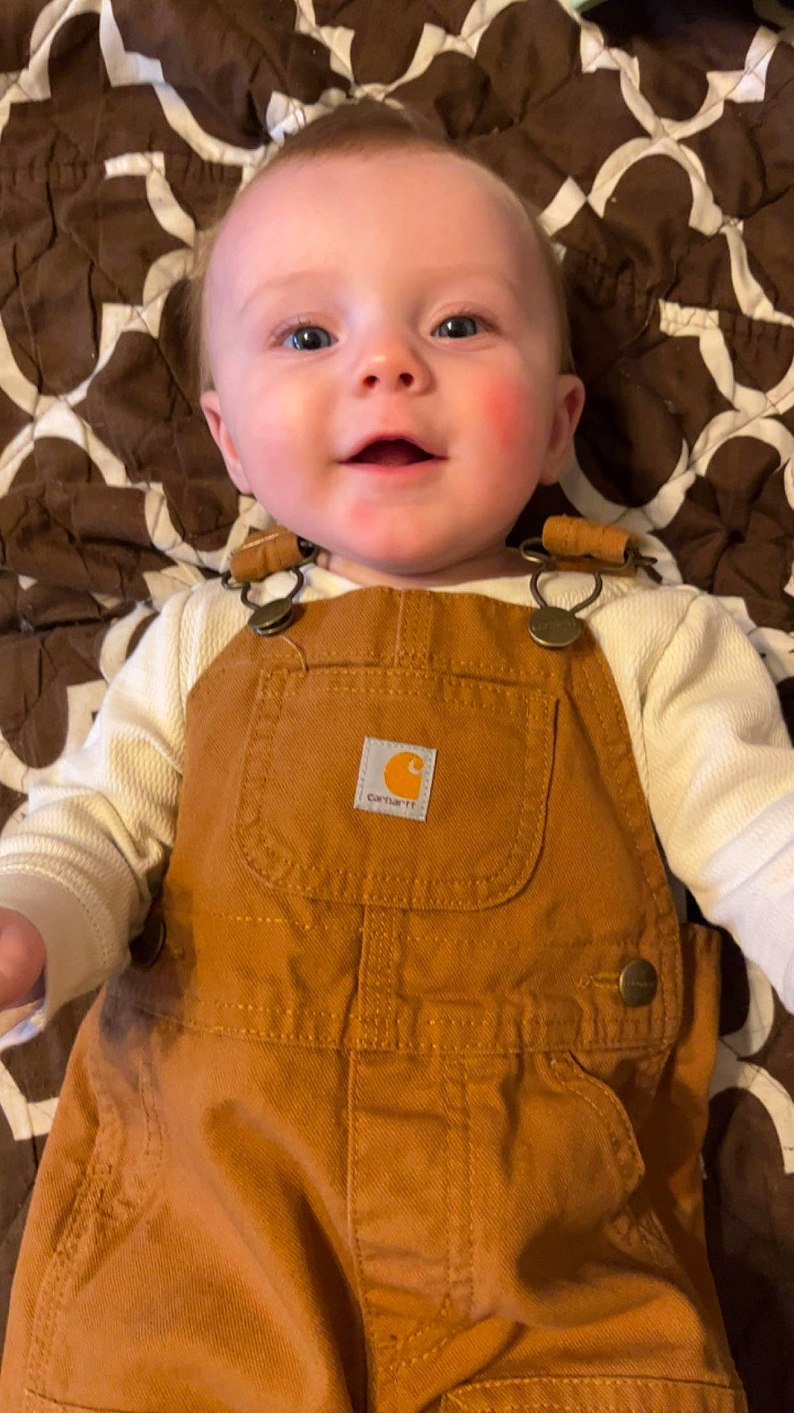 William Nicholas is registered to the contest to win money with this photo: baby, baby_toddler_clothing, brown, cheek, child, chin, collar, eye, eyebrow, gesture, happy, iris, nose, outerwear, pattern, person, skin, sleeve, smile, textile