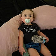 Azura joined the competition — help win amazing prizes! baby, pacifier, bottle, water_bottle, black_shirt, pink_cushion, blue_shorts, infant, child, sitting, indoors, soft_furniture, cute, relaxed, person, young_child, clothing, face, hand, looking_away