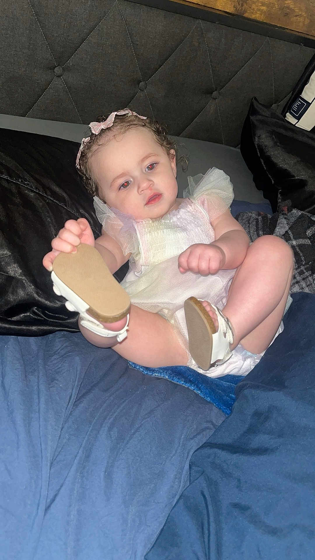 Azura joined the competition — help win amazing prizes! toddler, child, baby, bed, bedding, blue, black, dress, headband, white_shoes, curly_hair, indoor, portrait, playful, person, face, skin, cute, rest, lying_down