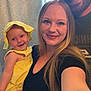 Harper is registered to the contest to win money with this photo: baby, woman, man, smile, family, selfie, yellow_clothing, hat, long_hair, beard, cap, indoor, curtain, holding, portrait, happy, person, casual, skin, closeup