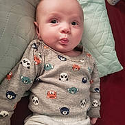 Krayzin is registered to the contest to win money with this photo: animal_print, baby, bed, child, clothing, cute, expression, face, hand, head, indoor, infant, lying_down, person, pillow, quilted, sleepwear, smiling, soft_fabric, sweater