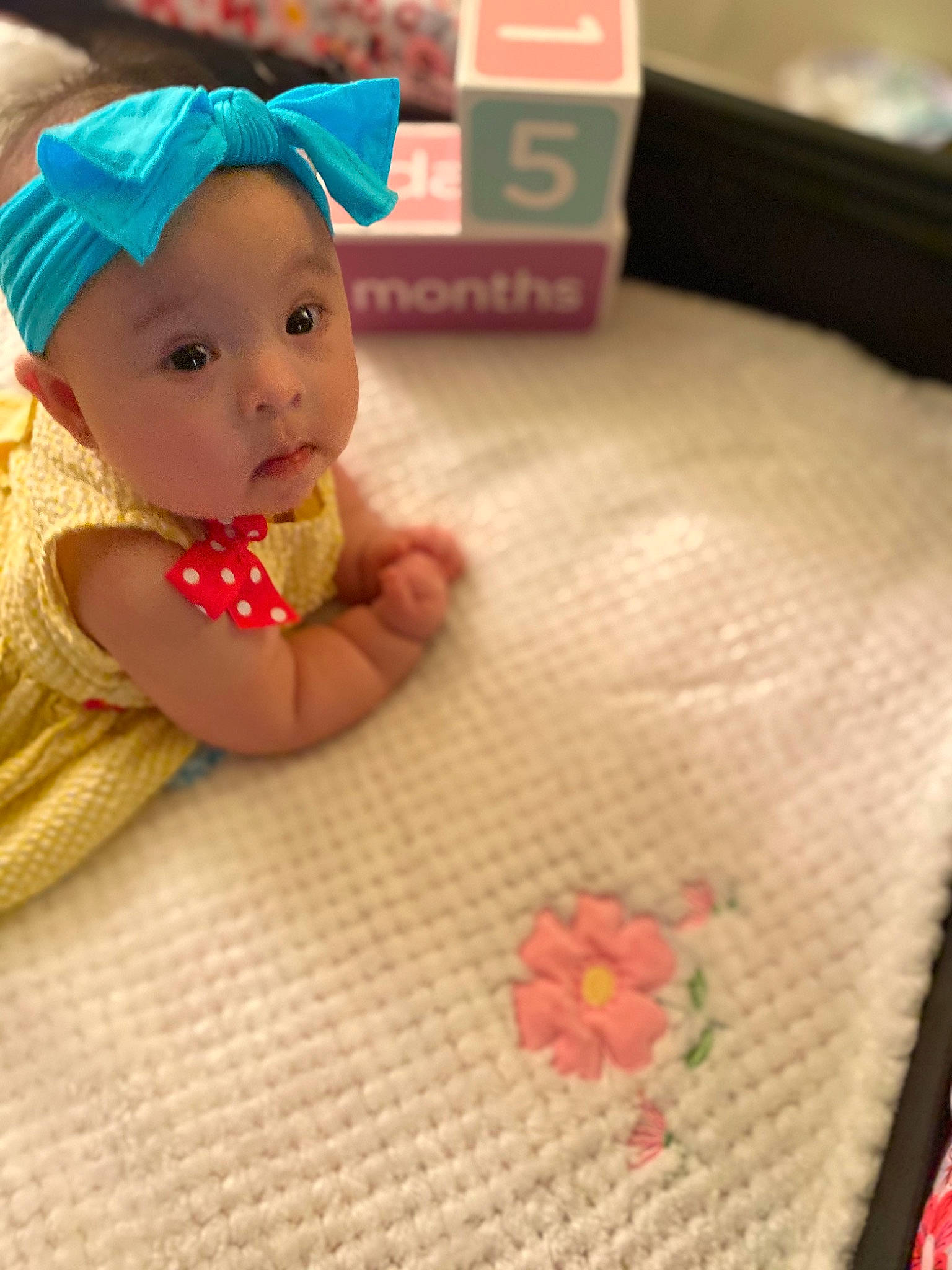 Khloe joined the competition — help win amazing prizes! art, baby, baby_products, baby_toys, cap, child, doll, fashion_accessory, figurine, flooring, happy, headwear, nail, pattern, peach, person, plastic, play, surprise, sweetness