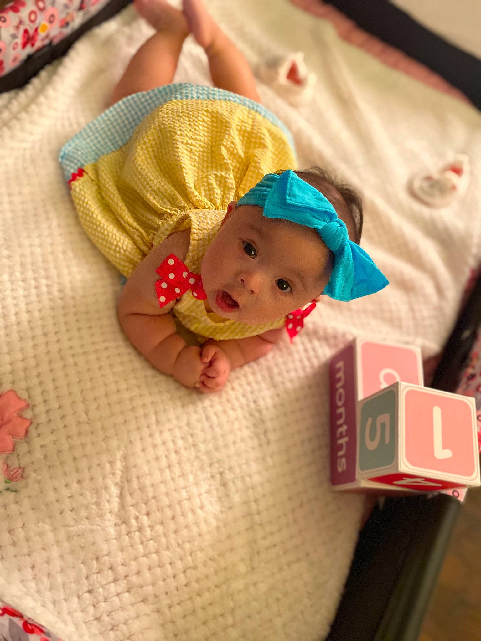 Khloe joined the competition — help win amazing prizes! baby, baby_products, baby_toddler_clothing, carmine, cheek, child, comfort, fashion_accessory, finger, flooring, fun, happy, head, headwear, linens, person, red, sitting, smile, surprise