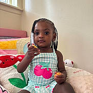 Kamira joined the competition — help win amazing prizes! child, toddler, girl, braided_hair, beads, plush_pillow, bedroom, toy, sitting, indoor, cute, clothing, patterned_outfit, window, light, face, person, young_child, comfort, relaxed