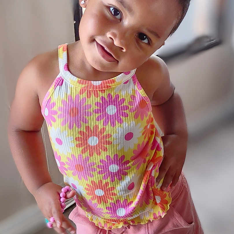 Aniyah joined the competition — help win amazing prizes! bodypart, child, clothing, dress, face, female, finger, footwear, formalwear, girl, hand, happy, head, person, photography, portrait, sandal, shoe, shorts, smile