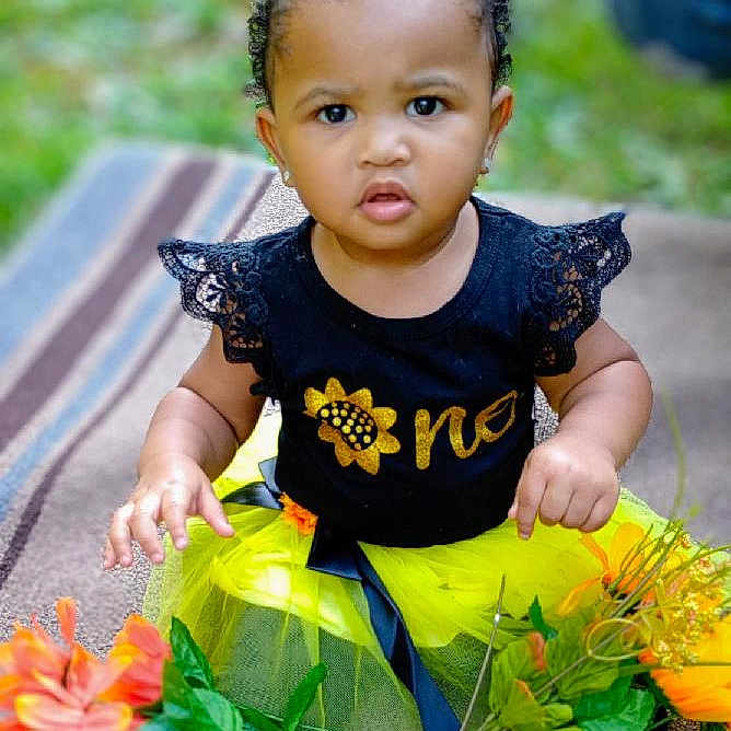 Amiyah joined the competition — help win amazing prizes! boy, child, clothing, dress, face, flower, flowerarrangement, flowerbouquet, grass, head, male, pants, person, petal, photography, plant, portrait, pottedplant, sitting, sleeve