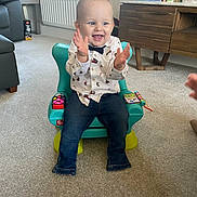Grayson joined the competition — help win amazing prizes! toddler, child, clapping, smiling, indoor, living_room, toy_chair, carpet, window, furniture, jeans, shirt, bow_tie, holiday_cards, decorations, toy, person, happy, home, casual