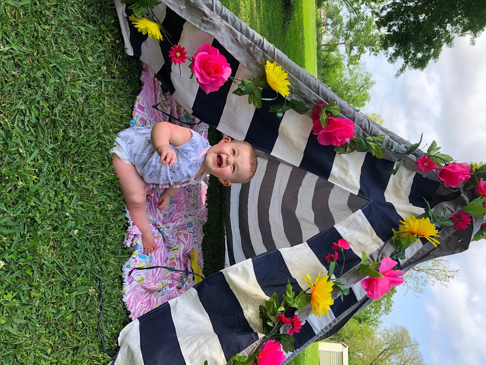 Haylie is registered to the contest to win money with this photo: automotive_wheel_system, botany, cloud, event, flag, flag_of_the_united_states, flower, fun, grass, happy, leisure, magenta, pattern, people_in_nature, person, pink, plant, pole, sky, tree