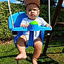 baby, child, swing, outdoor, grass, greenery, cap, sunlight, shadow, blue_sky, summer, playground, person, legs, feet, clothing, toy, nature, daytime, expression