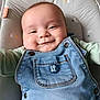 baby, smiling, denim_overall, cute, infant, face, happy, child, clothing, seat, cushion, button, portrait, young_child, indoor, baby_clothes, head, skin, person, relaxing