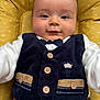 Nolan a rejoint le concours — aidez-le/la à gagner de superbes lots ! baby, bow_tie, buttons, child, closeup, clothing, comfortable, cute, face, happy, indoor, infant, person, portrait, sitting, smile, soft_fabric, vest, yellow_cushion, young