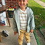 Jamarcus is registered to the contest to win money with this photo: brick_wall, car, casual, child, concrete_floor, daylight, grass, hair, happy, jacket, outdoor, pants, person, porch, shirt, sidewalk, smiling, sneakers, standing, table