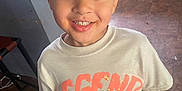 Jamarcus joined the competition — help win amazing prizes! boy, cabinet, cap, cartoon, casual, child, clothing, countertop, floor, graphic_tshirt, happy, hat, indoors, kitchen, looking_up, person, smile, standing, tile_floor, tshirt