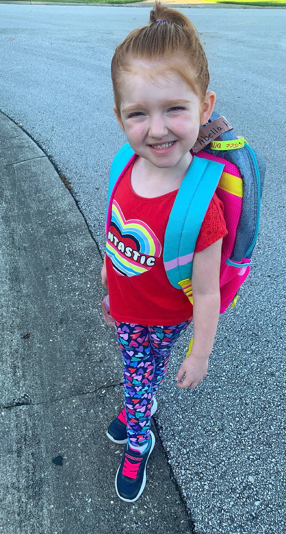 Abella is registered to the contest to win money with this photo: asphalt, baby_toddler_clothing, cool, electric_blue, eye, face, grass, hair, hairstyle, happy, head, joy, outerwear, person, personal_protective_equipment, pink, recreation, sleeve, smile, sportswear