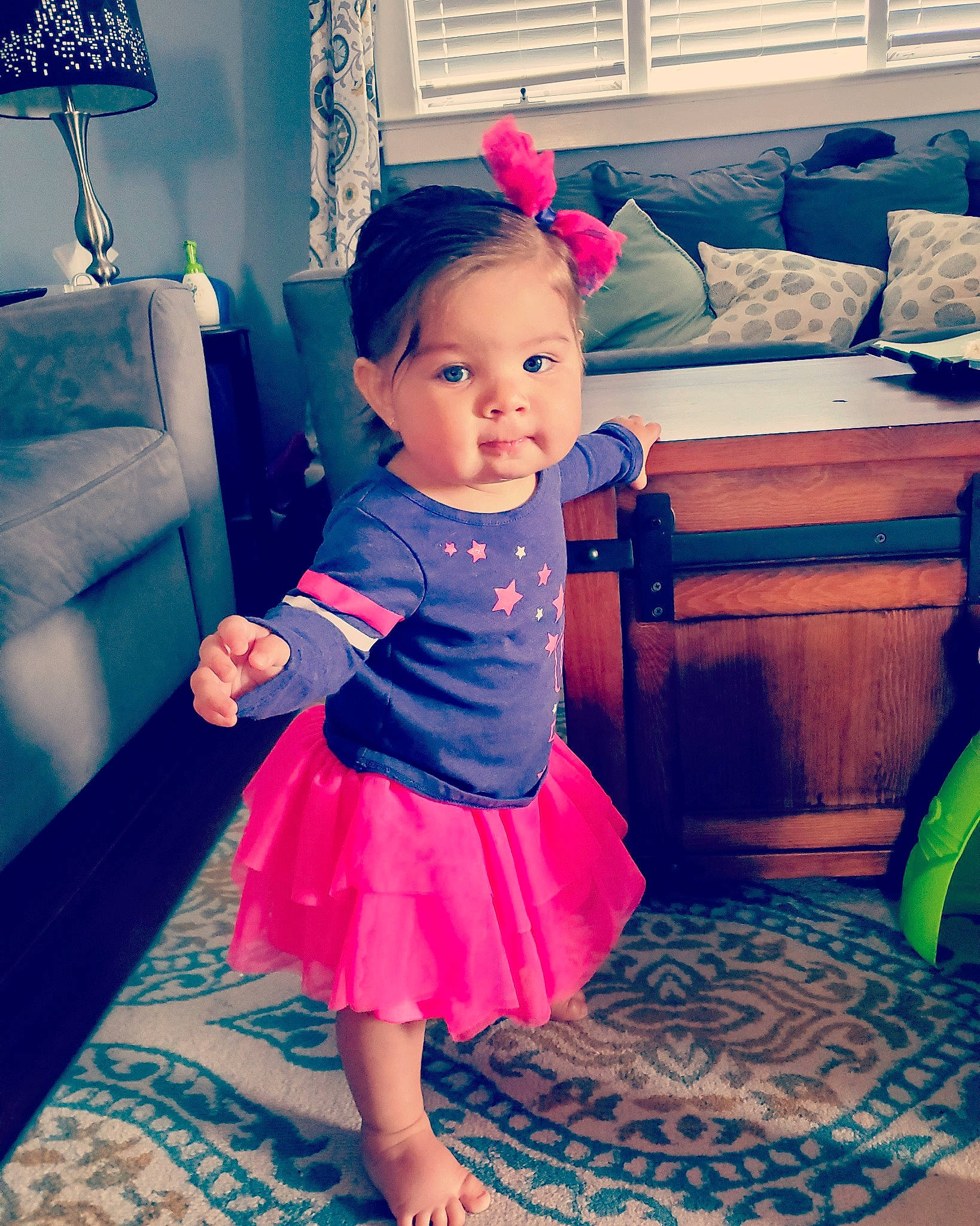 Eliana is registered to the contest to win money with this photo: baby, baby_toddler_clothing, child, couch, day_dress, embellishment, floor, flooring, home, home_accessories, interior_design, lamp, living_room, magenta, person, pillow, pink, room, teal, toddler