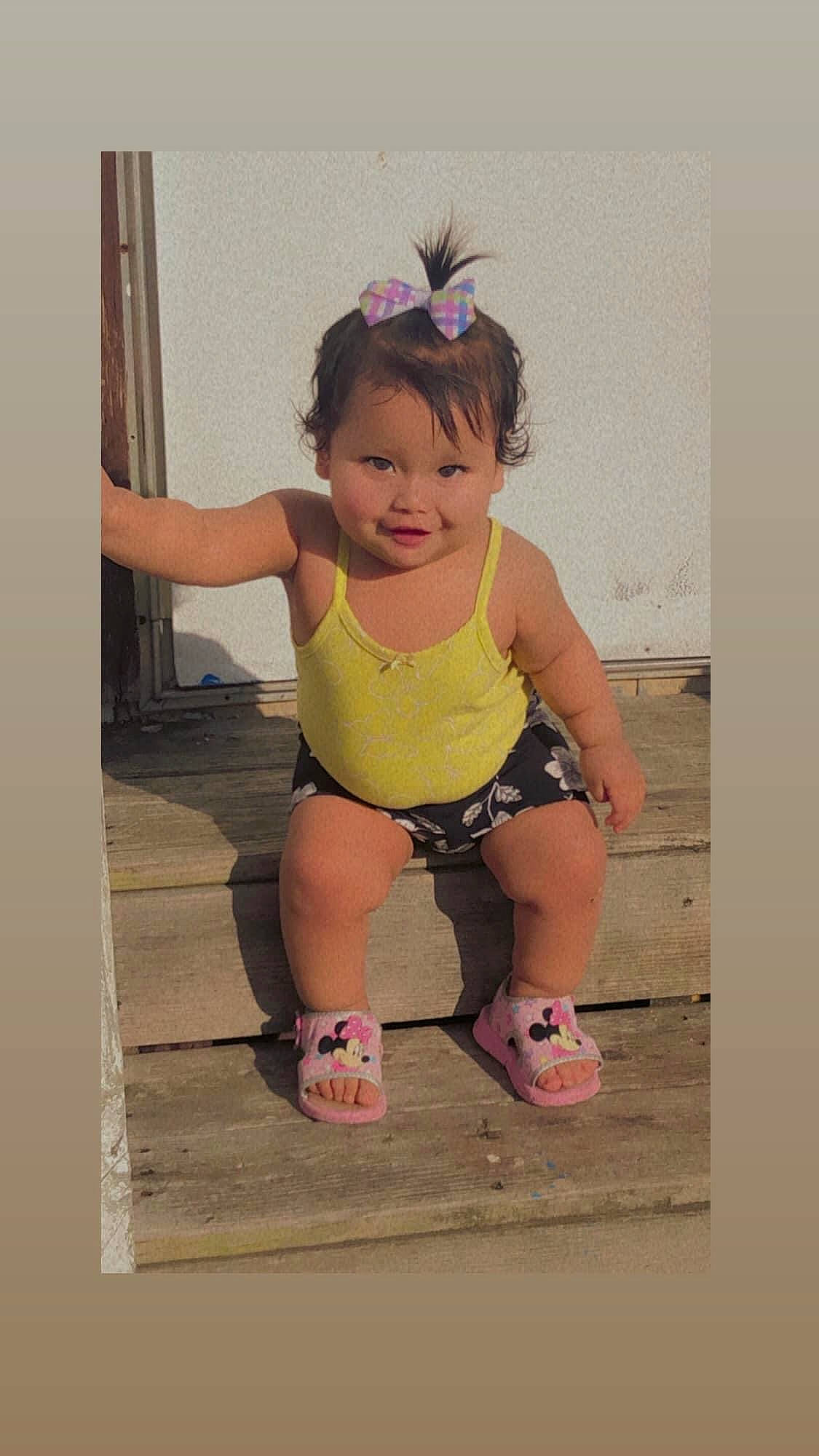 Katherine is registered to the contest to win money with this photo: arm, baby, baby_toddler_clothing, child, face, fun, happy, human_body, human_leg, joy, leisure, magenta, pattern, person, pink, play, recreation, sandal, sitting, smile