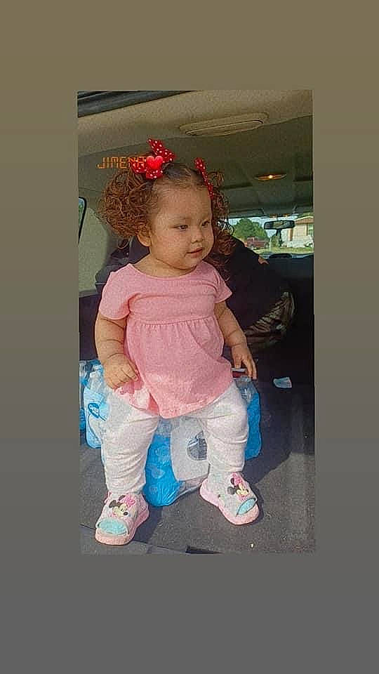 Katherine is registered to the contest to win money with this photo: baby, baby_toddler_clothing, baby_toys, cheek, child, costume, eye, fashion_accessory, fun, happy, human_body, magenta, pattern, person, play, product, room, sitting, sleeve, sock