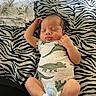 baby, infant, sleeping, dinosaur_onesie, blanket, zebra_pattern, cute, peaceful, child, newborn, clothing, sock, resting, lying_down, soft, portrait, indoors, cozy, small, adorable