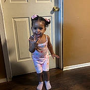 Laneigh joined the competition — help win amazing prizes! child, cute, door, expression, feet, happy, heart_pattern, home, indoor, pajamas, person, pink_bows, playful, smiling, socks, standing, toddler, wall, wooden_floor, young_child