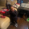 Laneigh joined the competition — help win amazing prizes! black_jacket, blanket, child, couch, curtains, happy, indoor, lamp, living_room, nike_shoebox, person, playful, pose, smiling, sneakers, table, toddler, toy, water_bottle, wood_floor