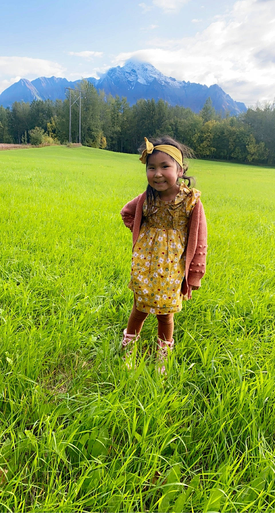 Cecelia joined the competition — help win amazing prizes! agriculture, cloud, ecoregion, grass, grass_family, grassland, green, groundcover, happy, headwear, joy, landscape, meadow, mountain, natural_landscape, people_in_nature, person, plain, plant, sky
