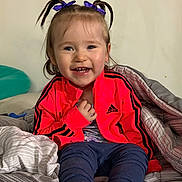 Blakely joined the competition — help win amazing prizes! adidas, blanket, child, clothing, cozy, cute, face, footwear, hair_bows, happy, indoor, jacket, pants, person, portrait, purple, sitting, smile, toddler, young_child
