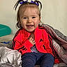 adidas, blanket, child, clothing, cozy, cute, face, footwear, hair_bows, happy, indoor, jacket, pants, person, portrait, purple, sitting, smile, toddler, young_child