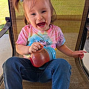 Blakely joined the competition — help win amazing prizes! casual_clothing, chair, child, cute, daytime, denim_jeans, fun, happy, outdoor, person, pigtails, playful, portrait, seat, sippy_cup, smiling, sunlight, tie_dye_shirt, toddler, young_child