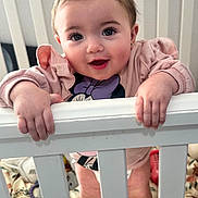 Leilani joined the competition — help win amazing prizes! baby, child, crib, pink_bow, smiling, standing, sweater, blanket, indoor, cute, hands, face, person, infant, happy, home, portrait, baby_girl, railing, toy