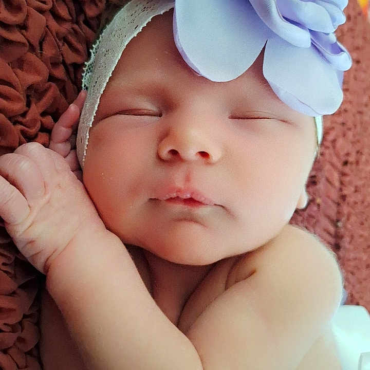 Journee is registered to the contest to win money with this photo: baby, bodypart, bonnet, cap, clothing, face, finger, hand, hat, head, newborn, person, photography, portrait, sleeping