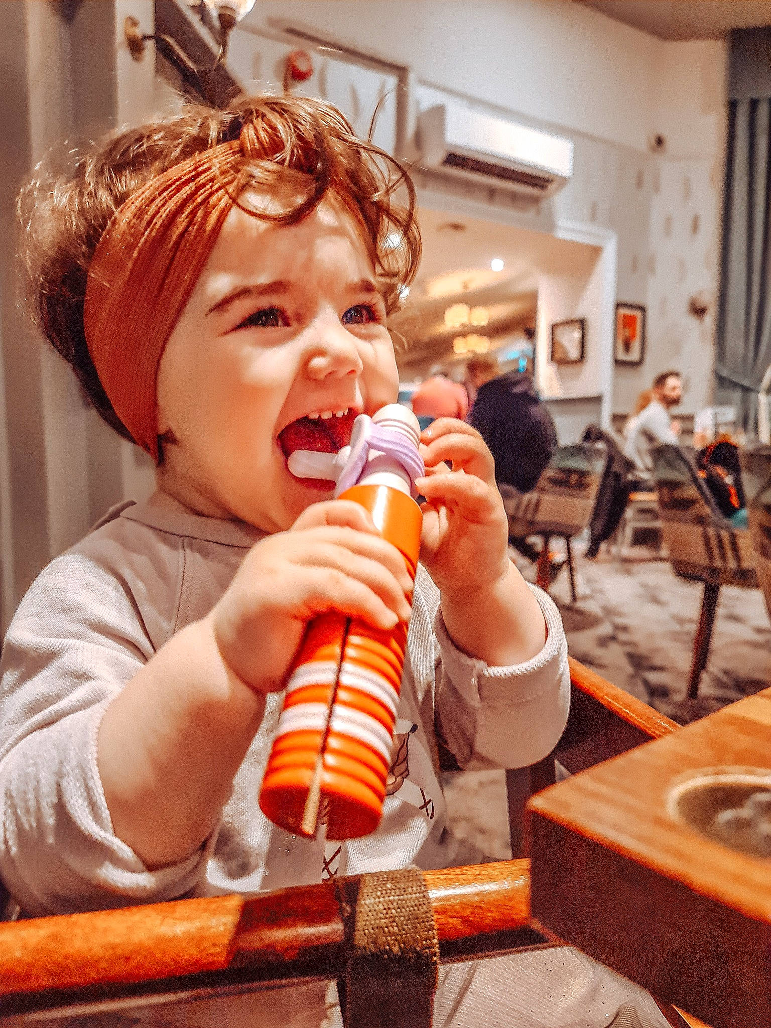 Leyla is registered to the contest to win money with this photo: baby, chair, child, comfort_food, drinking, eyelash, finger, finger_food, food_craving, fun, happy, headwear, junk_food, mouth, nail, nose, orange, person, sweetness, table