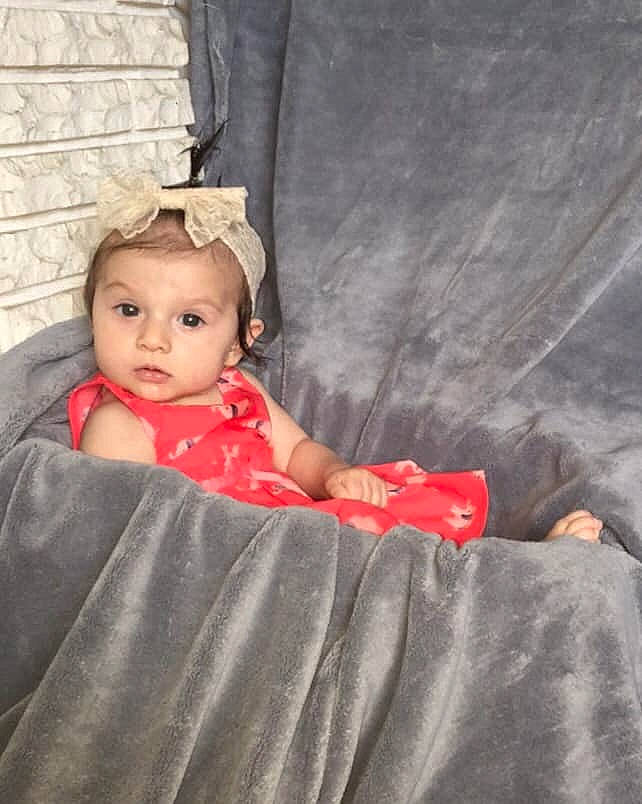 Avalina is registered to the contest to win money with this photo: baby, child, eye, person, play, product, red, sitting, skin, smile, toddler