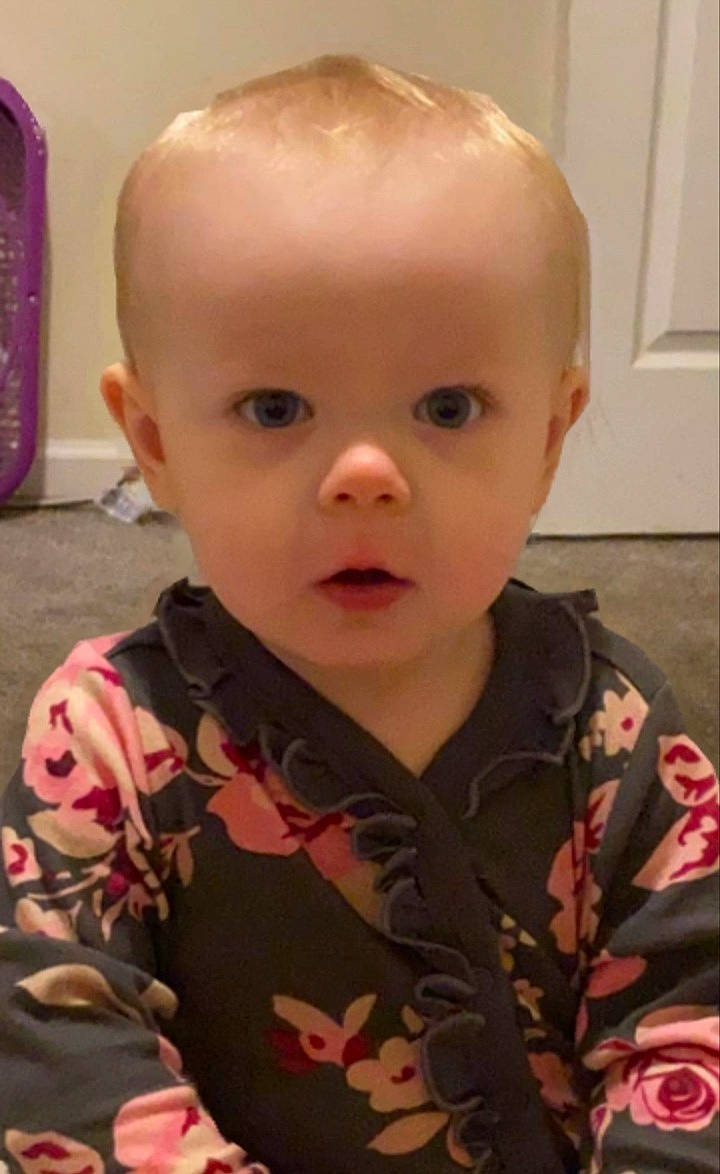 Everest is registered to the contest to win money with this photo: baby, baby_toddler_clothing, cheek, child, ear, eye, eyelash, fun, human_body, iris, lip, military_camouflage, mouth, nose, pattern, person, pink, skin, sleeve, standing