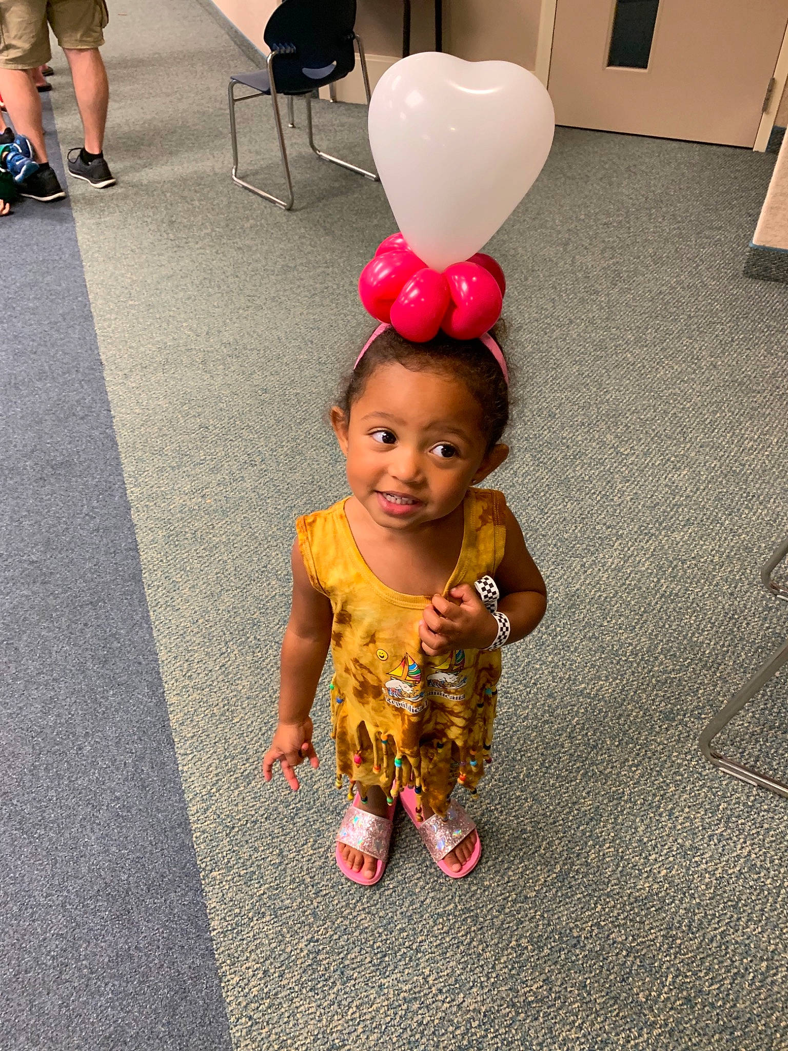 Amayah is registered to the contest to win money with this photo: balloon, child, dress, face, floor, flooring, footwear, fun, happy, head, joy, party_supply, people, person, play, skin, smile, snapshot, standing, toddler