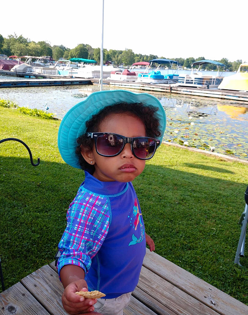 Amayah is registered to the contest to win money with this photo: child, cool, eyewear, fun, glasses, goggles, grass, headgear, leisure, people, person, personal_protective_equipment, pink, recreation, smile, summer, sunglasses, toddler, tourism, turquoise