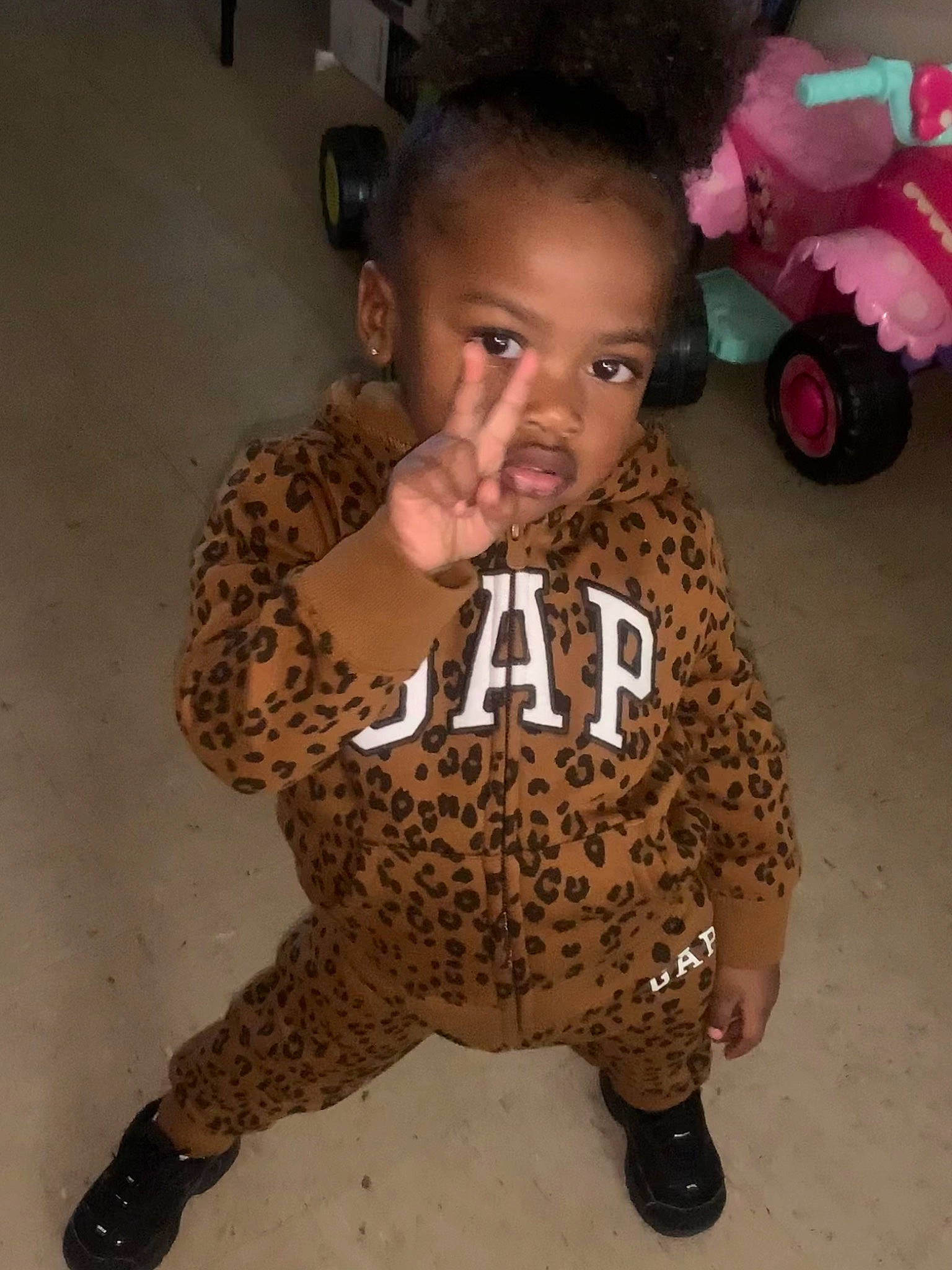 Johnai is registered to the contest to win money with this photo: afro, baby_toddler_clothing, child, flooring, fun, fur, hair, head, human_leg, knee, military_camouflage, pattern, person, skin, sleeve, terrestrial_animal, thigh, thumb, tire, toddler