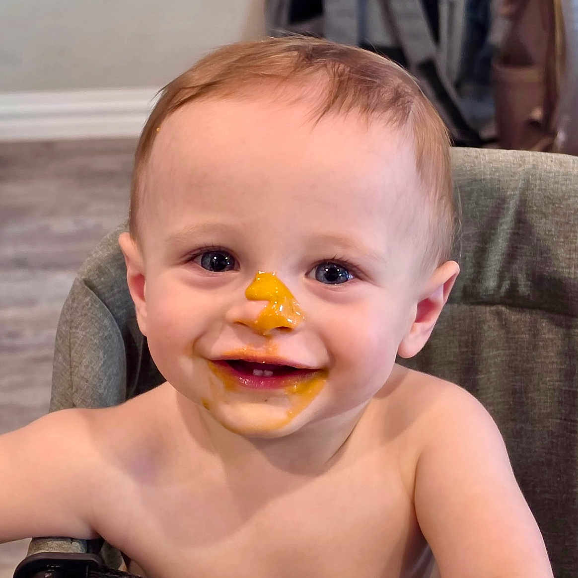 Cooper joined the competition — help win amazing prizes! baby, child, messy_face, food, high_chair, smile, happy, cute, indoor, face, skin, mouth, eyes, hair, table, feeding, infant, expression, person, toddler