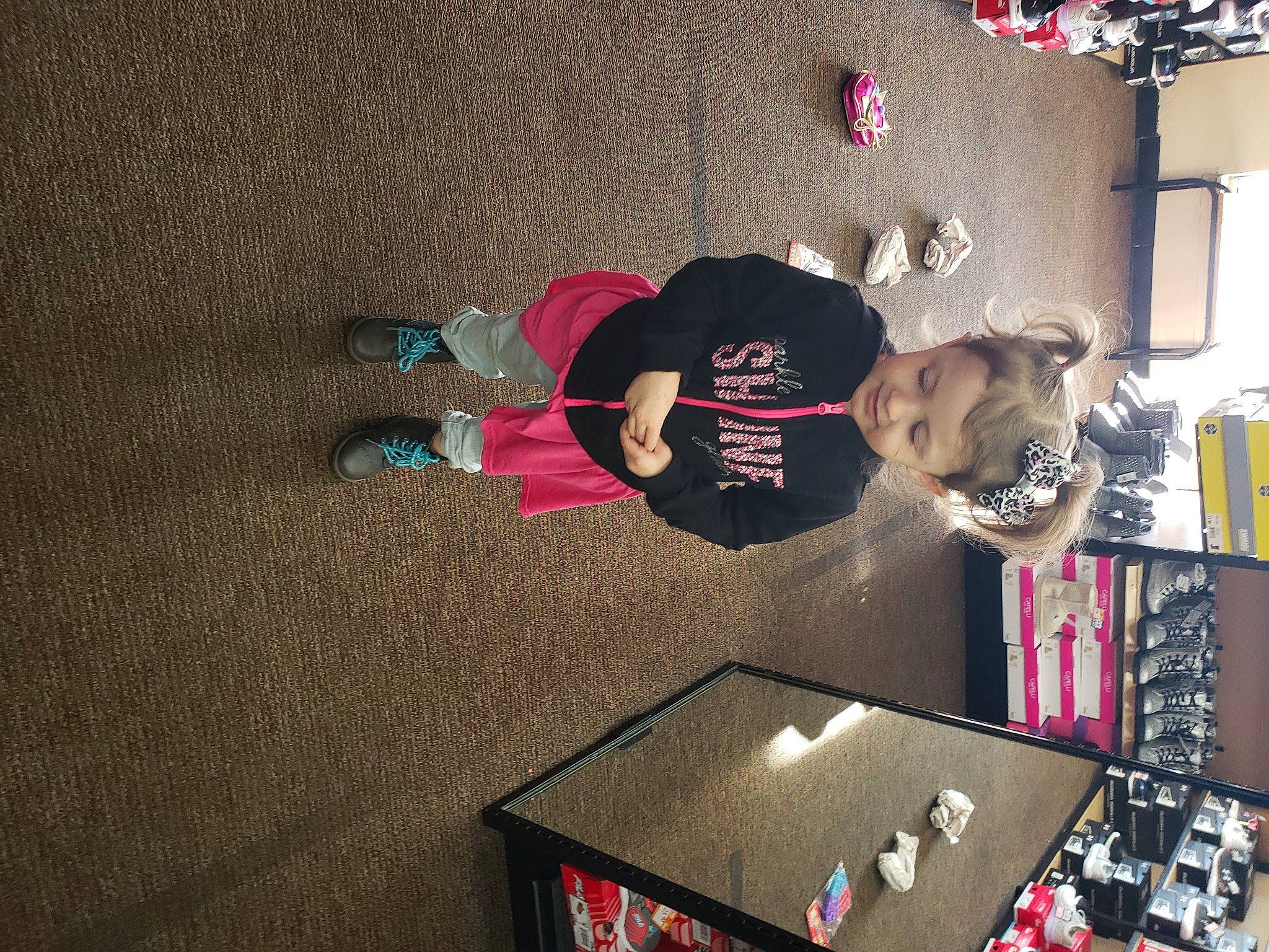 Karleigh is registered to the contest to win money with this photo: carmine, display_device, floor, flooring, fun, games, hardwood, machine, musical_instrument, person, play, recreation, room, shelf, shelving, t_shirt, visual_arts, walking_shoe, wall, wood