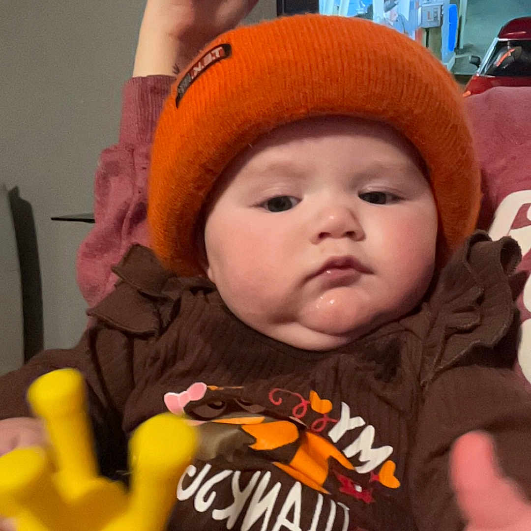 Ellamae is registered to the contest to win money with this photo: baby, beanie, bodypart, bonnet, cap, car, clothing, face, finger, furniture, glove, hand, hat, head, newborn, person, photography, portrait, transportation, vehicle