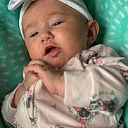 Mckinnleigh is registered to the contest to win money with this photo: baby, blanket, bow, child, closeup, clothing, cute, expression, face, hands, headband, indoor, infant, lying_down, minnie_mouse, onesie, portrait, sleepwear, soft, teal