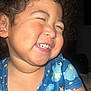 toddler, child, curly_hair, smiling, laughing, blue_shirt, stars_pattern, cloud_pattern, happy, portrait, face, cheeks, teeth, indoor, closeup, cute, joyful, person, clothing, baby