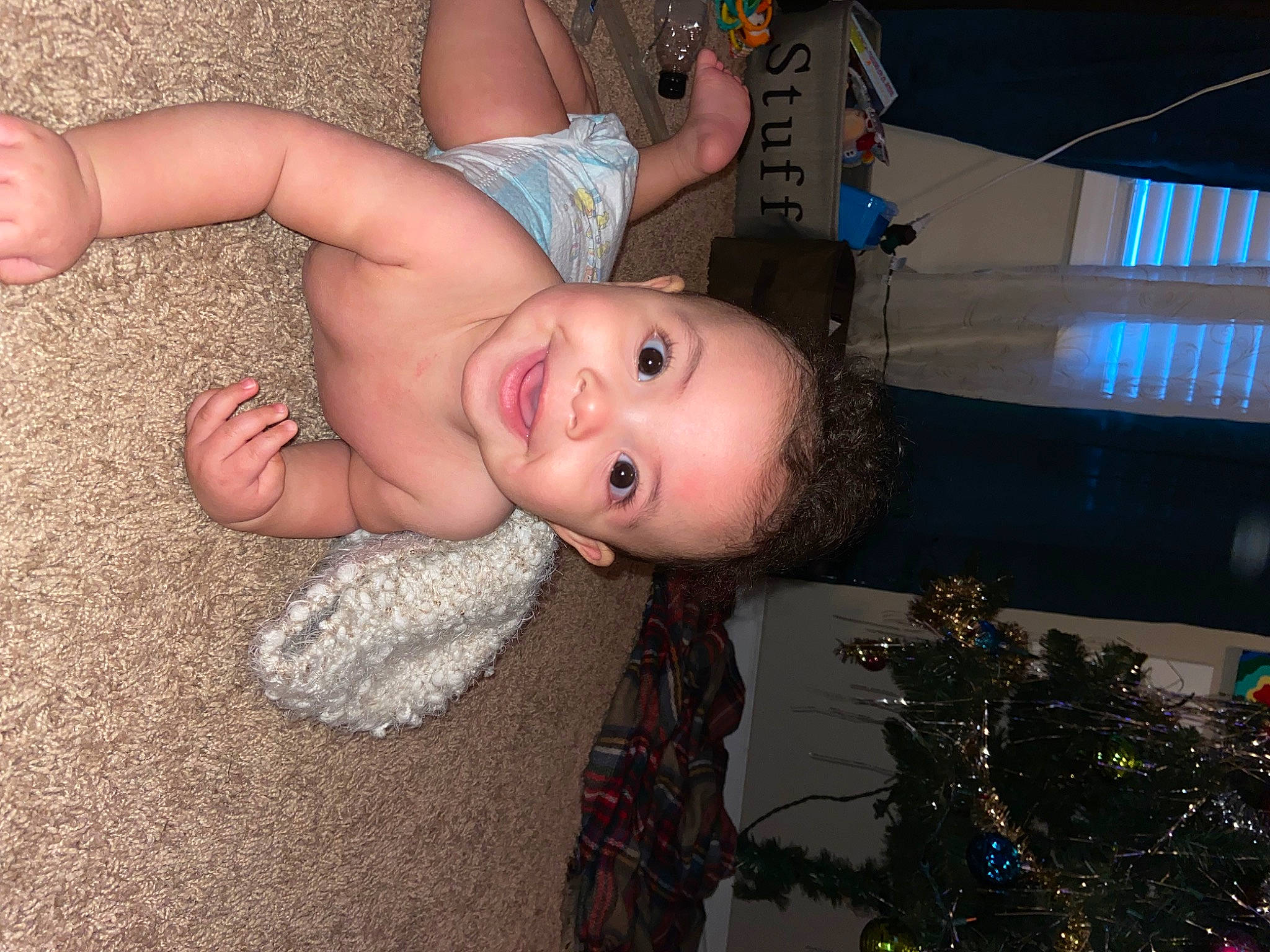 Caisen is registered to the contest to win money with this photo: baby, black, child, christmas_tree, eye, facial_expression, finger, fun, hair, hairstyle, happy, head, human_body, joy, mouth, organ, person, skin, smile, thumb