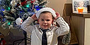 Milann a rejoint le concours — aidez-le/la à gagner de superbes lots ! boy, candle, celebration, child, christmas_tree, decoration, festive, floor, furniture, holiday, home, indoor, picture_frame, santa_hat, shirt, smiling, socks, table, tie, tile_floor
